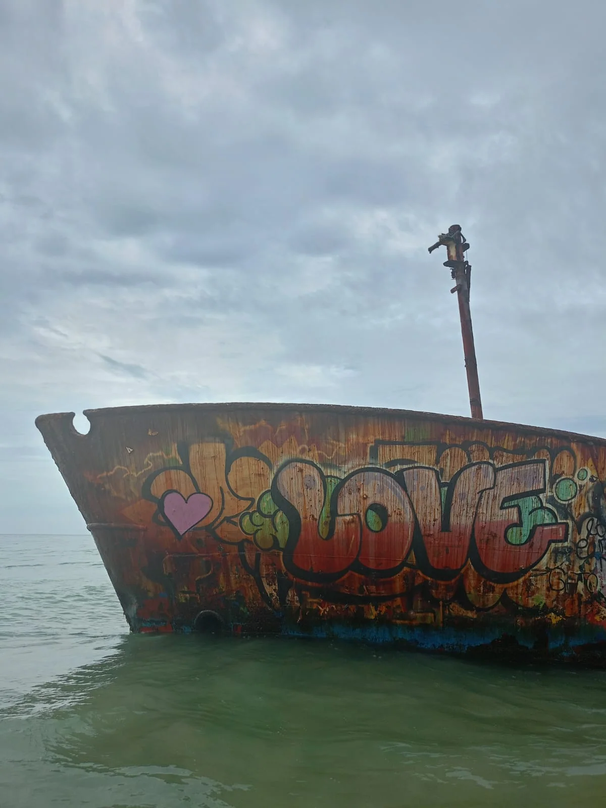 Colorful weathered boat off the coast at Punta Uva